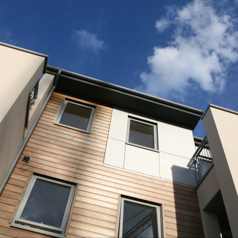 Smart modern low-rise apartments with softwood and aluminium cladding.