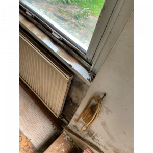Damp behind a radiator underneath a window - Anderson Wilde & Harris - expert building surveyors