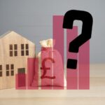 Wooden house with bag of money behind bard chart with question mark