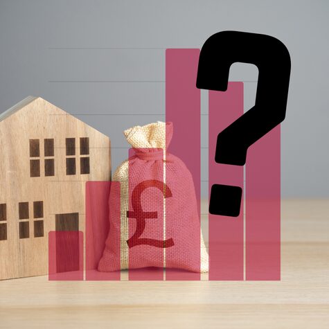 Wooden house with bag of money behind bard chart with question mark